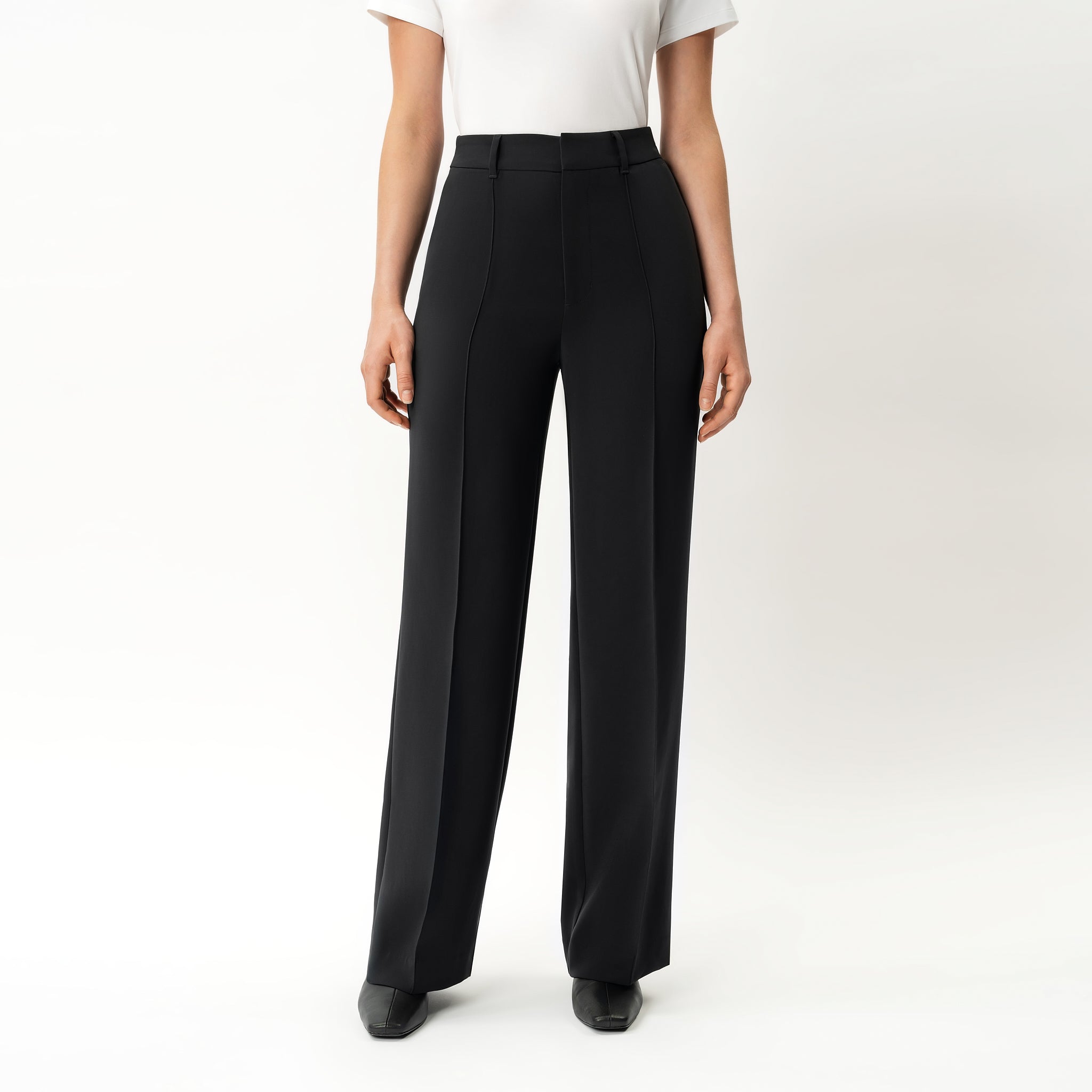 Black Ninepine Crepe Relaxed Trousers shown on model from front in studio.